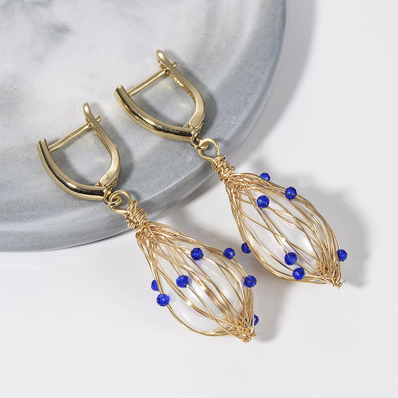 Wire wrapped pearl earrings in Blue